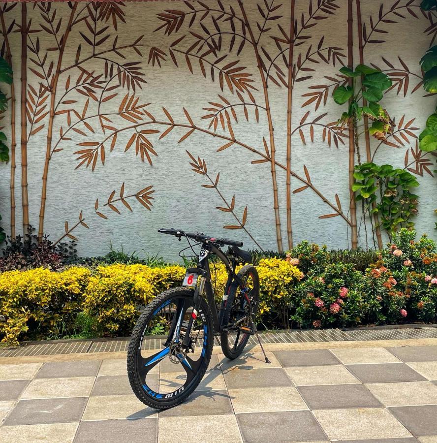 Radisson Blu Plaza Resort & Convention Centre Карджат Экстерьер фото A bicycle parked in front of a wall with a bamboo design