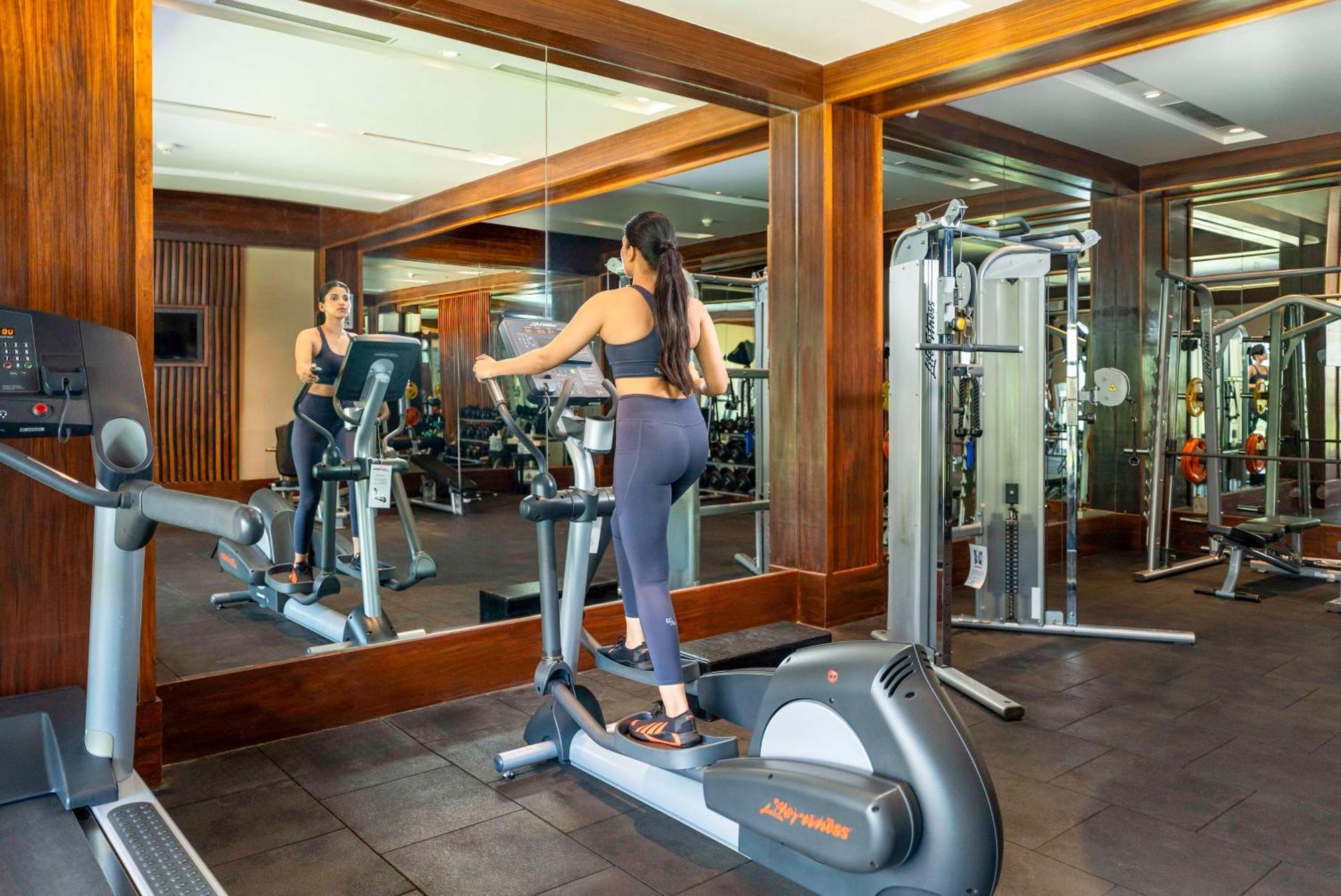 Radisson Blu Plaza Resort & Convention Centre Карджат Экстерьер фото A woman on an elliptical trainer